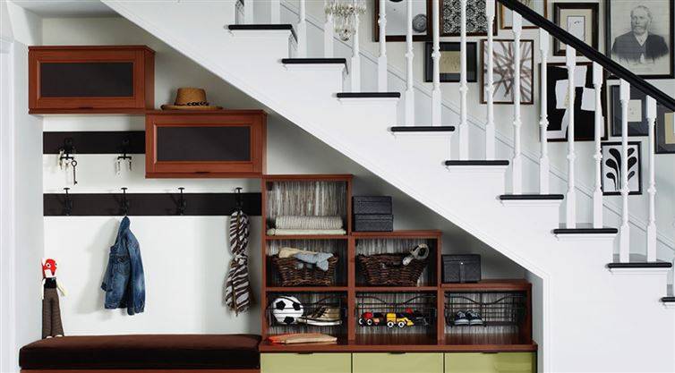 Organize shoes and coats under the stairs to keep the clutter away