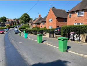 Neighbors blockade their street with wheelie bins to stop workers from parking outside homes